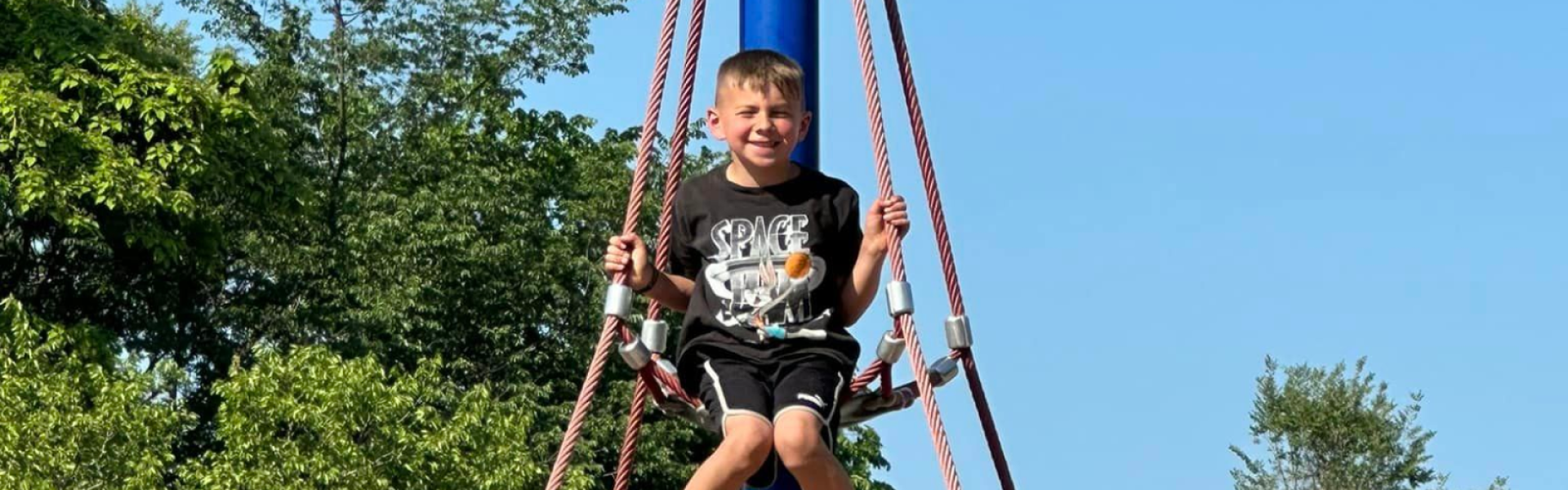boy hanging on a rope